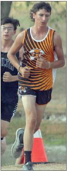 Zach Hammack gets through a gully ahead of a Moulton runner midway through the race. He placed 56th. Sticker Photo By Darrell Vyvjala
