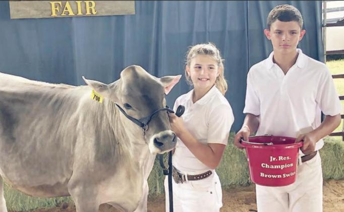DAIRY SHOW WINNER – In the Fayette County Fair dairy show, Landry Zapalac (left) of the Schulenburg FFA won junior showmanship champion, reserve champion Brown Swiss and reserve champion Holstein. Also shown is Blaine Zapalac (right).
