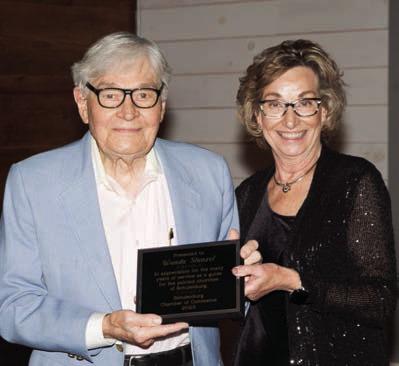 Ted Stanzel (left), accepting for his wife, Wanda