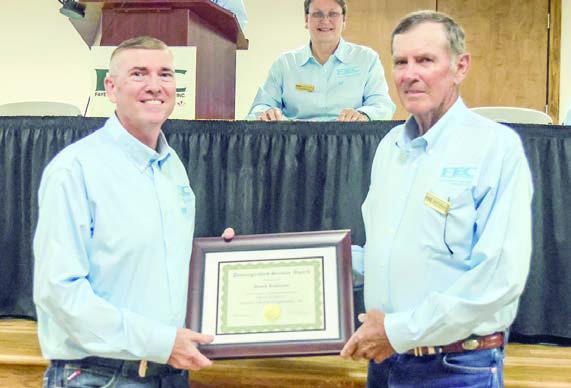 David Lehmann (right), District 1 director, retired from the board of directors after serving for 45 years. Lehmann was presented a distinguished service award from General Manager/CEO Doug Lambert (left).