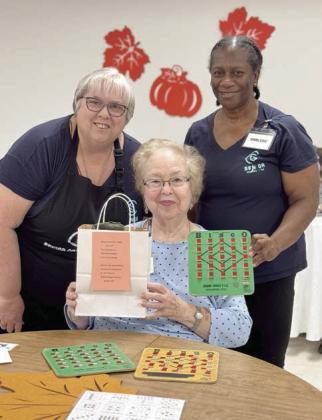 PHOTO AT LEFT – An extraordinary prize was won by Aileen Kaspar (center) on Monday, Nov. 4. Elizabeth Fox of Freyburg Hall visited Senior Connections for a program and she donated a gift bag with a T-shirt, hat and tickets to an upcoming concert. The prize winner will soon get her name put in a hat for a VIP table at the Roger Creager concert. Kasper gifted it to Kathy Carpenter (left) and Darlene Williams (right) called the game.