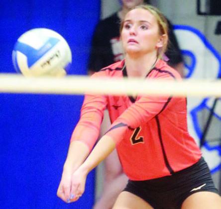 Miranda Bonner picks up a dig in the first set against Rice Consolidated. Sticker Photo By Darrell Vyvjala