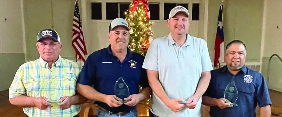 MEMBERSHIP MILESTONES – Receiving awards for reaching milestones as members of the Schulenburg Volunteer Fire Department, along with their years of membership, were: From left – Quentin Riche, 20 years Darren Guentert, 20 years Dustin Machicek, 20 years Pete Garcia, 20 years Sticker Photo By Darrell Vyvjala