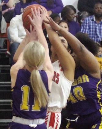 Ruby Rodriguez draws a foul on a baseline drive in the first half against Weimar. Sticker Photo By Darrell Vyvjala