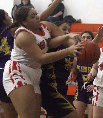 Arianna Vincent battles for an offensive rebound in the fourth quarter Friday. Sticker Photo By Darrell Vyvjala
