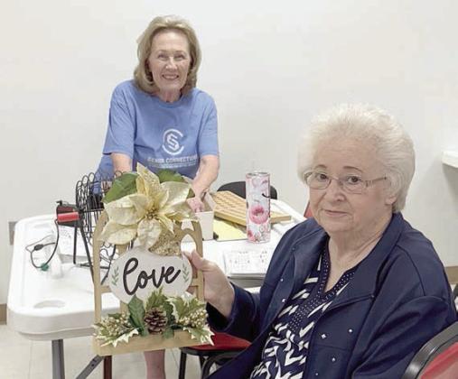 Aft eratie-br eaking game between three contestants, Helen Ohnheiser (front) won the blackout prize in a bingo game called by Sharon Rodriguez (back) in Schulenburg. The prize was created by Martha Beckmann.