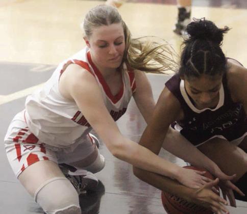 Kaylee Beyer battles for a loose ball in the fourth quarter of the game against Flatonia. Sticker Photo By Darrell Vyvjala