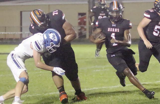 Calvin Thompson (No. 71) clears the way for Da’Terrion Houston (No. 1) on a 22-yard screen pass in the second quarter. Sticker Photo By Layne Vyvjala