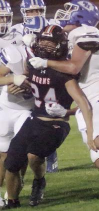 Mason Kunschick drags a pair of Indians to finish off a 9-yard gain in the second quarter. Sticker Photo By Layne Vyvjala