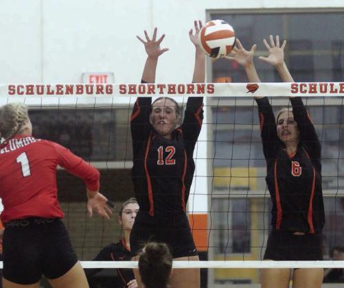 Grace Schramek (No. 12) and Clara Magliolo (right) team up to reject a Lady Cardinal attack last Tuesday at SHS Gym. Sticker Photo By Darrell Vyvjala kills, 2 block assists, 8 digs ----------------------------------- SEPT. 13