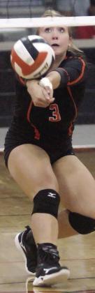Reagan Dusek saves a ball near the net in game two last Tuesday. Sticker Photo By Darrell Vyvjala