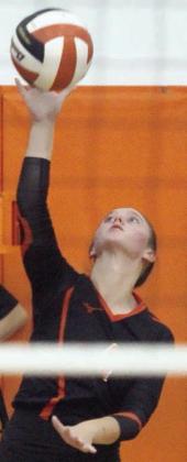 Avery Helms sends a serve on its way in the second set against Columbus. Sticker Photo By Darrell Vyvjala