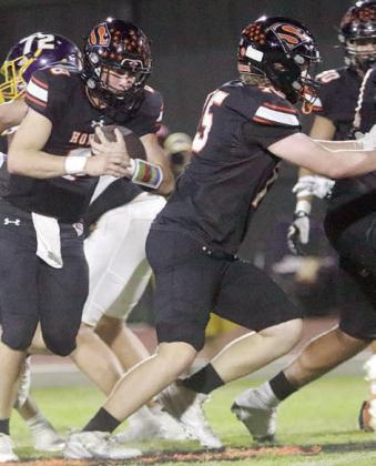 Owen Brenek (left) uses a block from Colton Matura on a 6-yard gain in the second quarter. Sticker Photo By Layne Vyvjala
