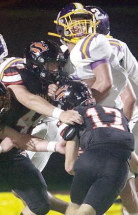 Caden Herzik (No. 17) and Aidan Mendez combine to stop Ace Mesa in the second quarter. Sticker Photo By Layne Vyvjala