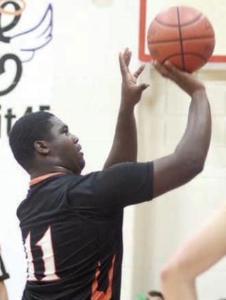 Tavondrick Ellison releases a third made free throw in his last four tries late in the Horns’ win Friday. Sticker Photo By Darrell Vyvjala