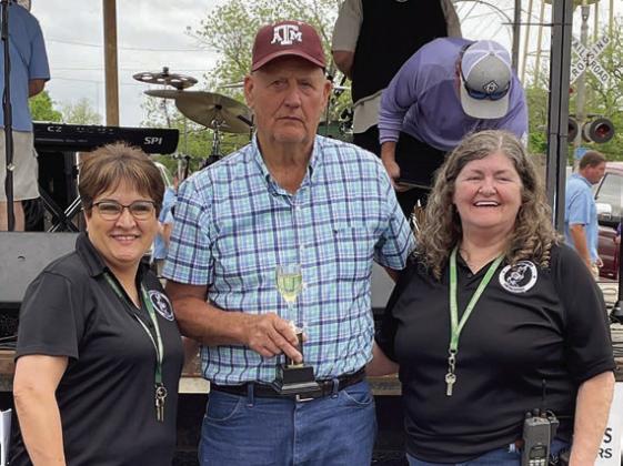 WINE - 1ST PLACE: Henry Kutac (center). Also shown are Sausagefest Committee members Liz Garcia Vaughan (left) and Debbie Preece. Sticker Photo By Darrell Vyvjala