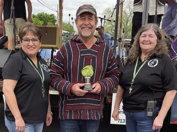 SAUERKRAUT - 2ND PLACE: Michael Ripper (center). Also shown are Sausagefest Committee members Liz Garcia Vaughan (left) and Debbie Preece. Sticker Photo By Darrell Vyvjala