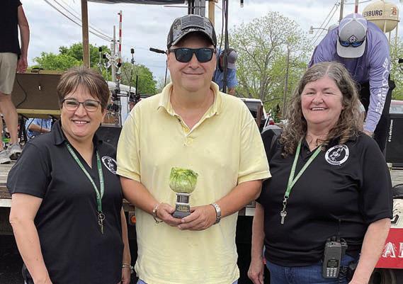 SAUERKRAUT - 3RD PLACE: Dennis Zarosky (center). Also shown are Sausagefest Committee members Liz Garcia Vaughan (left) and Debbie Preece. Sticker Photo By Darrell Vyvjala