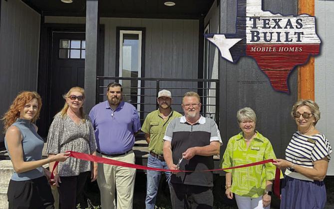 Representatives from Texas Built Motile Homes and the Schulenburg Chamber of Commerce shown at the ribbon cutting are (from left) Sara Robbins, office manager; Tammy Treybig, representing the Schulenburg Chamber of Commerce; Skylar Thompson, sales manager; Bryan Stacy, housing consultant; Tom Schadler, general manager; Nina Howard, representing the Schulenburg Chamber of Commerce; and Diana Mikesky, Schulenburg Chamber board president.
