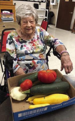 Irene Janda with her “one-ton” tomato she grew along with squash donated by Janda Nursery in Hostyn.
