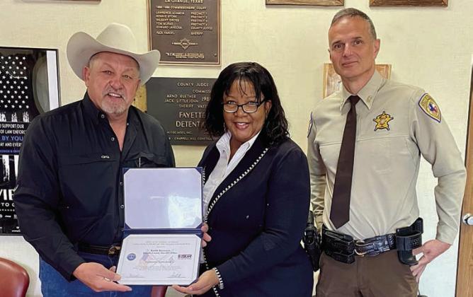Presenting Fayette County Sheriff Keith Korenek (left) with the Patriot Award were Deputy Hardy Hay (right) and a representative from the Office of Employer Support of the Guard and Reserve (center).