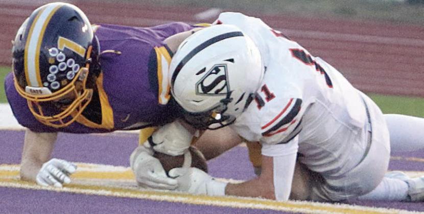 Nick Goode snatches the ball away from Cayden Conway in the end zone after an errant punt snap to give the Horns their only touchdown. Sticker Photo By Darrell Vyvjala