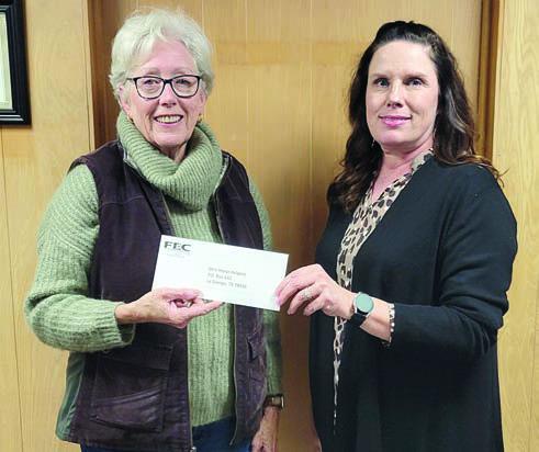 Funds donated by members of Fayette Electric Cooperative went to Mini Horse Helpers. Shown are (from left) Mini Horse Helpers vice president/executive director Sally Van Duyn and FEC marketing and training coordinator Tracy Denton.