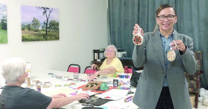 Paradigm at the Oak’s Pam Noell (right) with sun catchers that Betty Mulholand and Lillian Vanicek were assembling for her clients.