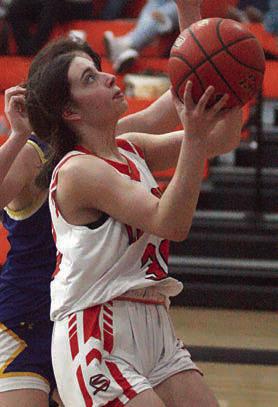 Fay Kutac drives in for a bucket in the fourth quarter. Sticker Photo By Darrell Vyvjala