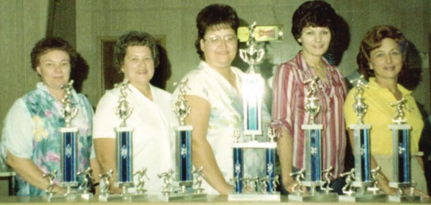Maxine (left) and her mates on the Pat’s Sweet Shop bowling team (continuing from left) Julie Stryk, Patsy Janacek, Alice Poth, and Pauline Farek along with some of the many trophies they won.