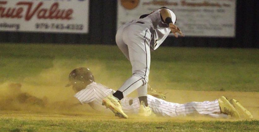 Reid Janda reaches out on a head-first slide to beat the tag of a Buffalo infielder for a theft of second base. Sticker Photo By Darrell Vyvjala