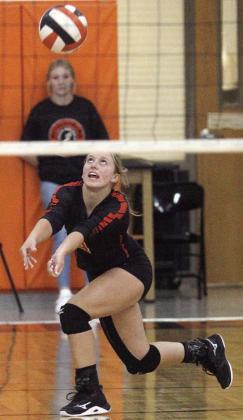 Avery Helms digs a Lady Cobra attack in game one of pool play during the Lady Horn Classic. Sticker Photo By Darrell Vyvjala
