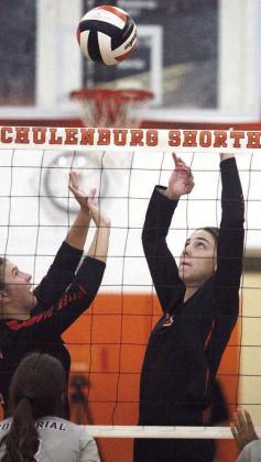 Landry Zapalac (left) sets up Meredith Magliolo for a kill in the Lady Horns 2-0 win over Industrial. Sticker Photo By Darrell Vyvjala