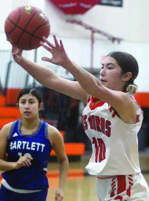 Gracie Burton passes to a teammate in the first game of the local tourney. Sticker Photo By Darrell Vyvjala