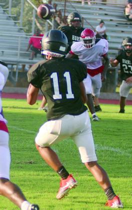 Byron Johnson runs a slant to meet Aaron Janecek’s pass for a touchdown during the scrimmage. Sticker Photo By Darrell Vyvjala