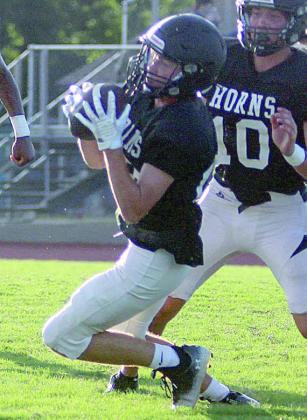 Nick Goode secures an interception against Lexington. Sticker Photo By Darrell Vyvjala