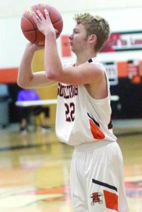 Caden Herzik lines up a three-pointer in the second quarter of the district opener. Sticker Photo By Darrell Vyvjala