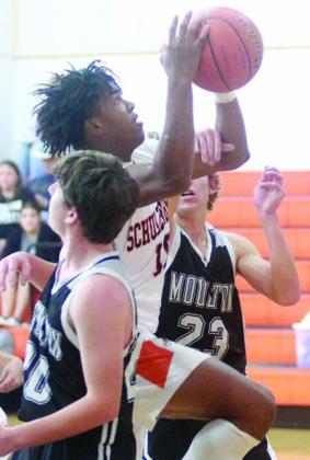 Da’Terrion Houston gets fouled on his way to the basket against Moulton. Sticker Photo By Darrell Vyvjala