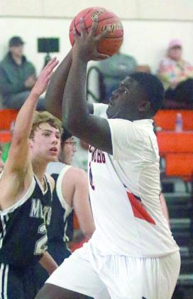 Tavondrick Ellison gets past a Bobkat on a drive in the first half of the Horns’ win on Dec. 27. Sticker Photo By Darrell Vyvjala