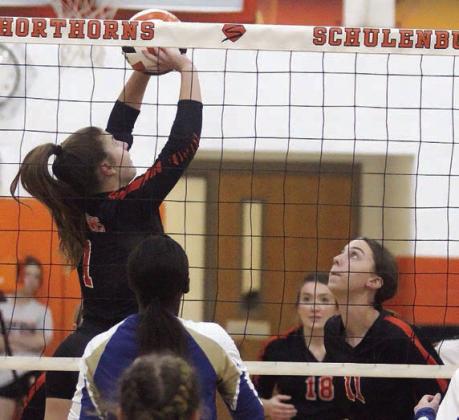 Landry Zapalac (left) sets up Meredith Magliolo (No. 11) for a quick-set kill in game one last Tuesday. Sticker Photo By Darrell Vyvjala