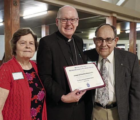 St. Rose of Lima Catholic School selected Charlene Kolenovsky (left) and Jerome Kolenovsky (right) as its recipient of the 2024 St. Mother Elizabeth Ann Seton Award. Making the presentation on April 25 in Shiner was Bishop Brendan Cahill (center) of the Victoria Diocese.