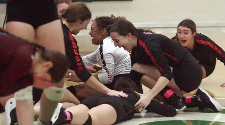 Lady Horn players drop to the floor in elation after securing the Class 2A Region IV championship Saturday afternoon. Sticker Photo By Darrell Vyvjala