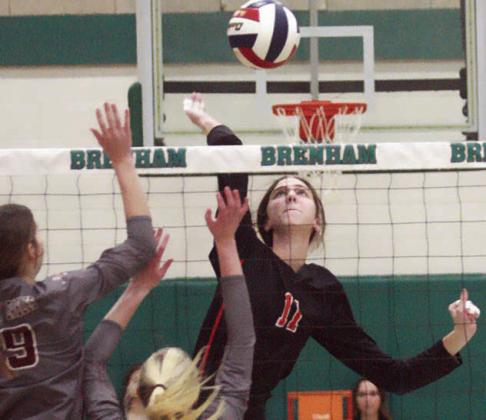 Collaborating for match point of the regional championship, Landry Zapalac sends the set and Meredith Magliolo swings for the kill. Sticker Photos By Darrell Vyvjala