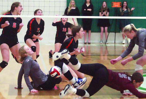 Meredith Magliolo (center) celebrates as three Lady Eagles fail to pick up her block early in the match. Teammates (from left) Tamara Otto, Landry Zapalac, and Keaton Walker join the jubilation. Sticker Photo By Darrell Vyvjala