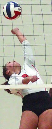Kieryn Adams makes a leaping, twisting save on a Johnson City attack in the third set. Sticker Photo By Darrell Vyvjala