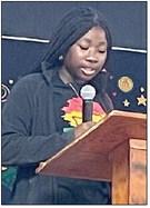 Brieyelle Moore reads an essay. Sticker Photo By Darrell Vyvjala