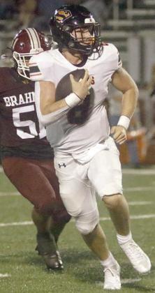 Owen Brenek scrambles away from a Brahma defender on a 17-yard gain in the third quarter. Sticker Photo By Darrell Vyvjala