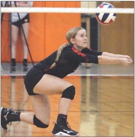 Madison Kunschick reaches to get to a Lago Vista attack in game one. Sticker Photo By Darrell Vyvjala