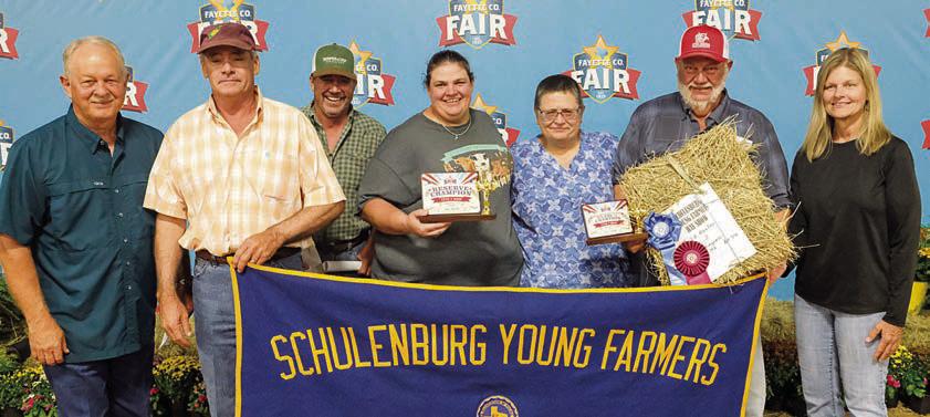 Reserve champion - Shown are (from left) Dennis Brower of BWI, Mark Stang, Matt Arthur of Bumper Crop Texas, Chelsea Moeller, Jennifer Moeller, Ed Moeller and Susan Wick of Schulenburg Young Farmers. Photo By Andy Behlen/Courtesy of Fayette County Record