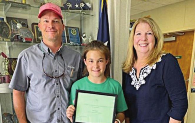 6TH GRADE • 3RD PLACE WINNER – Ella Herzik (center) of St. Michael Catholic School with her father, Russell Herzik (left), and NVCW “BFFD” chair Suzette Surman (right).